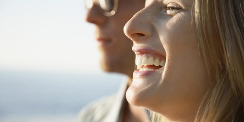 Couple smiling safely in the sun after reading Elan Medical Skin Clinic's blog about sun spots