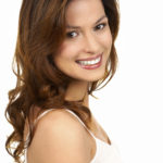 A lovely young woman smiling. Do you have scars that bother you? Speak to Sue Ibrahim at Elan Medical Skin Clinics in central London and Rayleigh, Essex