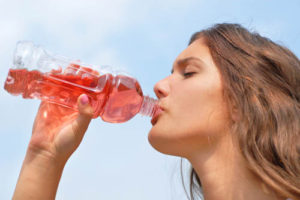 A girl drinks a sports drink - Essex skin expert from Elan Medical Skin Clinic in Rayleigh debunks the myths not based on scientific evidence